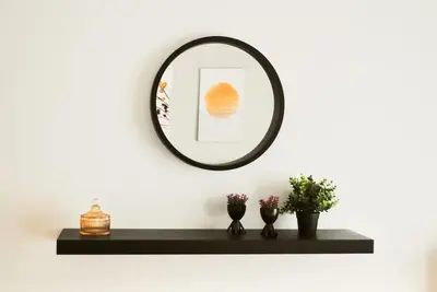 a mirror on a wall with a black shelf at GPK Lux 2BR - 7 min walking to Acropolis in Athens