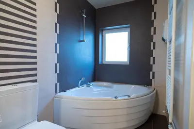 a bathroom with a tub and a window and a toilet at Acropolis metro st 3 bedrms 6 pers maisonette by MPS in Athens