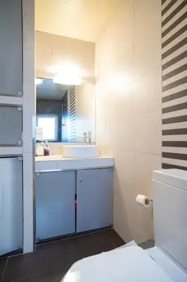 a bathroom with a white sink and a toilet at Acropolis metro st 3 bedrms 6 pers maisonette by MPS in Athens