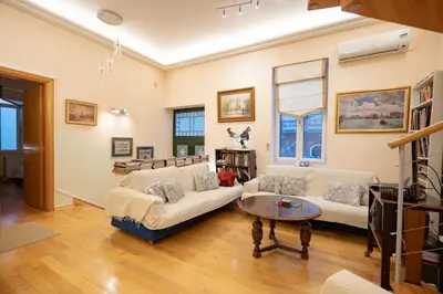 a living room with a couch and a table at Acropolis metro st 3 bedrms 6 pers maisonette by MPS in Athens