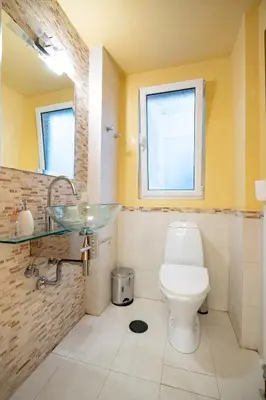 a bathroom with a toilet and a glass sink at Acropolis metro st 3 bedrms 6 pers maisonette by MPS in Athens
