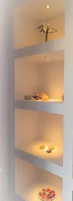 a shelf with plates and a vase on it at Overlooking the Acropolis in Athens