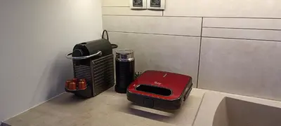 a room with a heater and a red suitcase at Overlooking the Acropolis in Athens