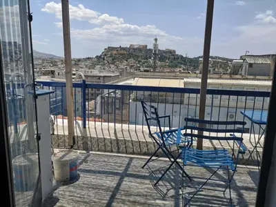 two chairs and a table on a balcony at Evripidou Experience - The Suite in Athens