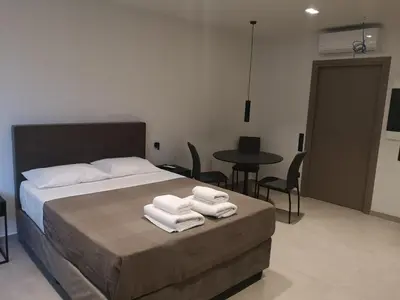 a bedroom with a bed with towels on it at Evripidou Experience - The Suite in Athens