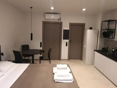 a room with a bed and a table and chairs at Evripidou Experience - The Suite in Athens