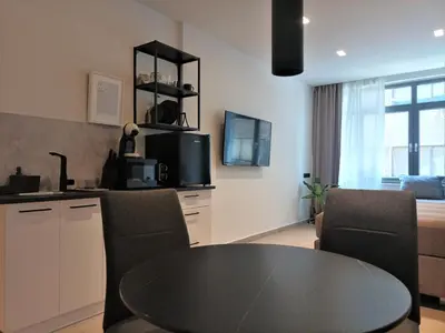 a kitchen and dining room with a table and chairs at Evripidou Experience - Triple Suite in Athens