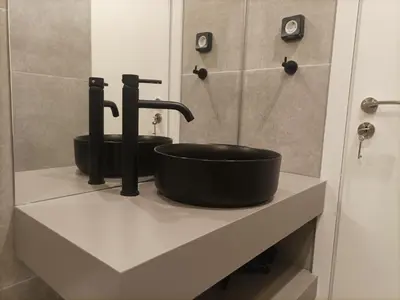 a bathroom with a black sink on a counter at Evripidou Experience - Triple Suite in Athens