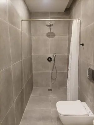 a bathroom with a shower with a toilet in it at Evripidou Experience - The smart double C in Athens