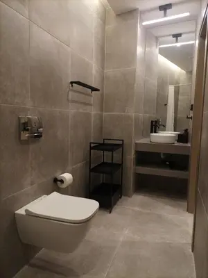 a bathroom with a toilet and a sink at Evripidou Experience - The smart double C in Athens