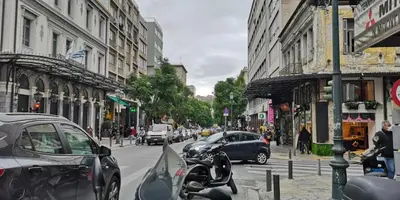 a busy city street with cars and a motorcycle parked at Evripidou Experience - The smart double C in Athens