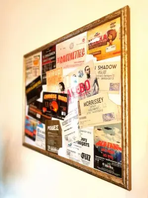 a picture frame hanging on a wall with publications at Lucy's apartment in Athens