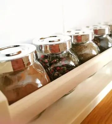 a row of glass jars sitting on a shelf at Lucy's apartment in Athens