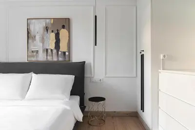 a bedroom with a bed and a stool next to it at Athenian Postmodern Gem in Athens
