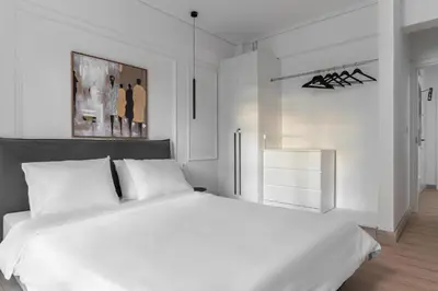 a white bedroom with a large white bed in it at Athenian Postmodern Gem in Athens
