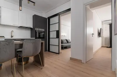 a kitchen and living room with a table and chairs at Athenian Postmodern Gem in Athens