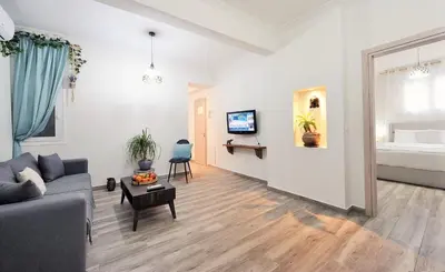 a living room with a couch and a bed at Bella Ciao Guest House in Athens