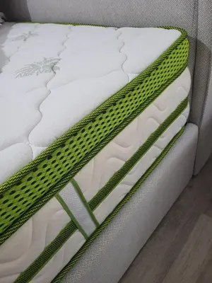 a close up of a white mattress with green trim at Bella Ciao Guest House in Athens