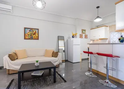a living room with a couch and a table at Renovated Lovely Apt next to Marina Flisvos in Athens