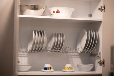 a kitchen with plates and bowls on shelves at Athenian Dream Apartment-Spacious Comfortable & Luxurious in a real Athenian neighborhood in Athens