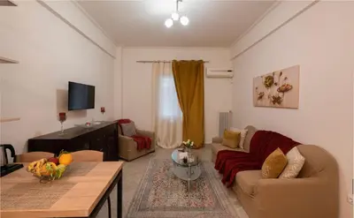 a living room with a couch and a table at Athenian Dream Apartment-Spacious Comfortable & Luxurious in a real Athenian neighborhood in Athens