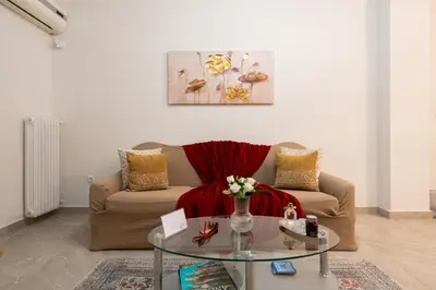 a living room with a couch and a glass table at Athenian Dream Apartment-Spacious Comfortable & Luxurious in a real Athenian neighborhood in Athens