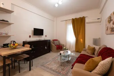 a living room with a couch and a table at Athenian Dream Apartment-Spacious Comfortable & Luxurious in a real Athenian neighborhood in Athens