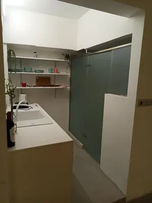 a kitchen with green and white cabinets and a sink at Mosaics Athens easystay in the Historical centre in Athens