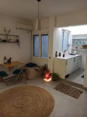 a living room with a kitchen and a table at Mosaics Athens easystay in the Historical centre in Athens