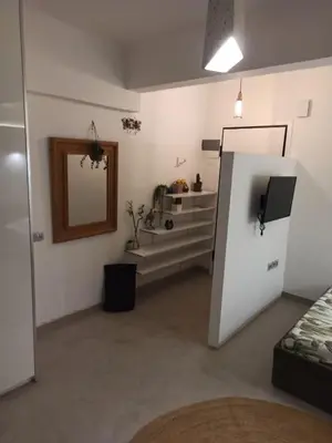 a living room with a refrigerator and a mirror at Mosaics Athens easystay in the Historical centre in Athens