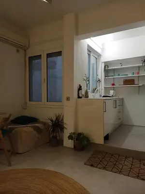 a living room with a sink and a kitchen at Mosaics Athens easystay in the Historical centre in Athens