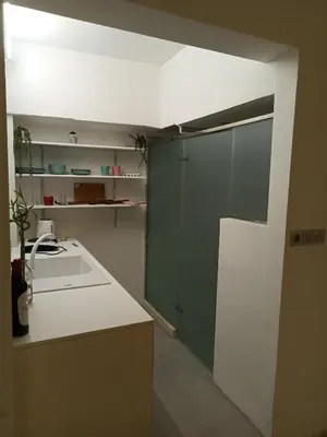 a kitchen with green cabinets and a white counter top at Mosaics Athens easystay in the Historical centre in Athens
