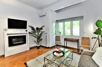 a living room with a couch and a fireplace at Kolonaki Jewel 1st floor feel like home properties in Athens