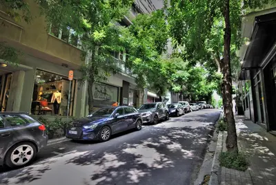 a row of cars parked on the side of a street at Kolonaki Jewel 1st floor feel like home properties in Athens
