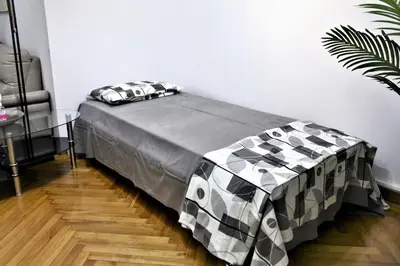 a bed in a room with a table and a bed sidx sidx sidx at Kolonaki Jewel 1st floor feel like home properties in Athens
