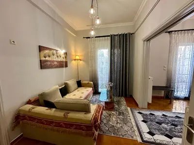 a living room with a couch and a bed in it at Bratis House Athens in Athens