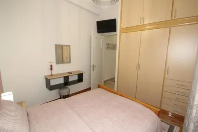 a bedroom with a bed and a desk in it at Bratis House Athens in Athens