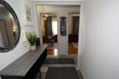 a living room with a table and a mirror at Bratis House Athens in Athens