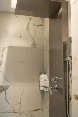 a shower in a bathroom with a shower backdoor at Heart Of Athens Apartments in Athens