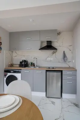 a kitchen with white appliances and a wooden table at Heart Of Athens Apartments in Athens