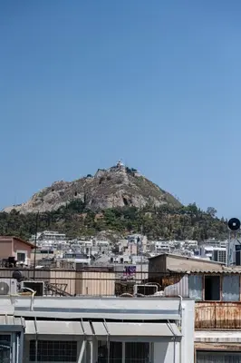 a mountain in the background of a city at Heart Of Athens Apartments in Athens