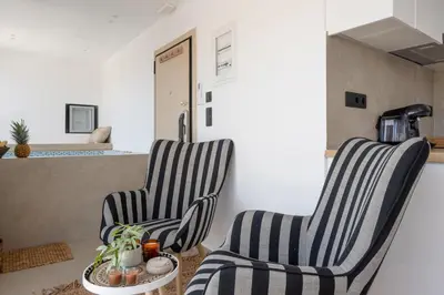 two chairs and a table in a living room at Heart Of Athens Apartments in Athens