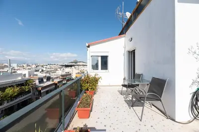 a balcony with a view of a city at Acropolis view Penthouse by WeHost Athens in Athens
