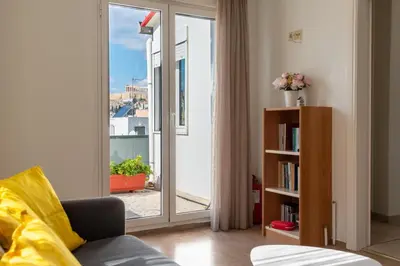 a living room with a sliding glass door to a balcony at Acropolis view Penthouse by WeHost Athens in Athens