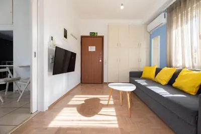 a living room with a couch and a table at Acropolis view Penthouse by WeHost Athens in Athens