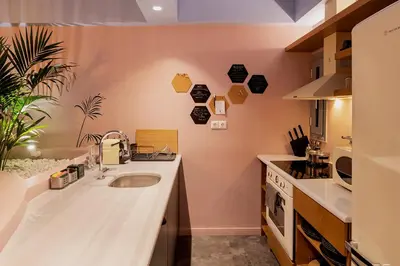 a kitchen with a sink and a counter top at Secret Garden Downtown in Athens