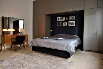 a bedroom with a large bed and a desk and a chair at Central studio in Monastiraki B in Athens