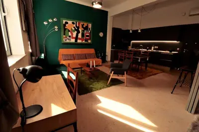a living room with green walls and a table and chairs at Central studio in Monastiraki B in Athens