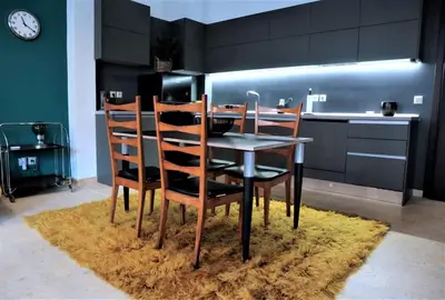 a kitchen with a table and chairs on a rug at Central studio in Monastiraki B in Athens