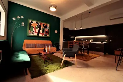 a living room with a couch and a dining room at Central studio in Monastiraki B in Athens